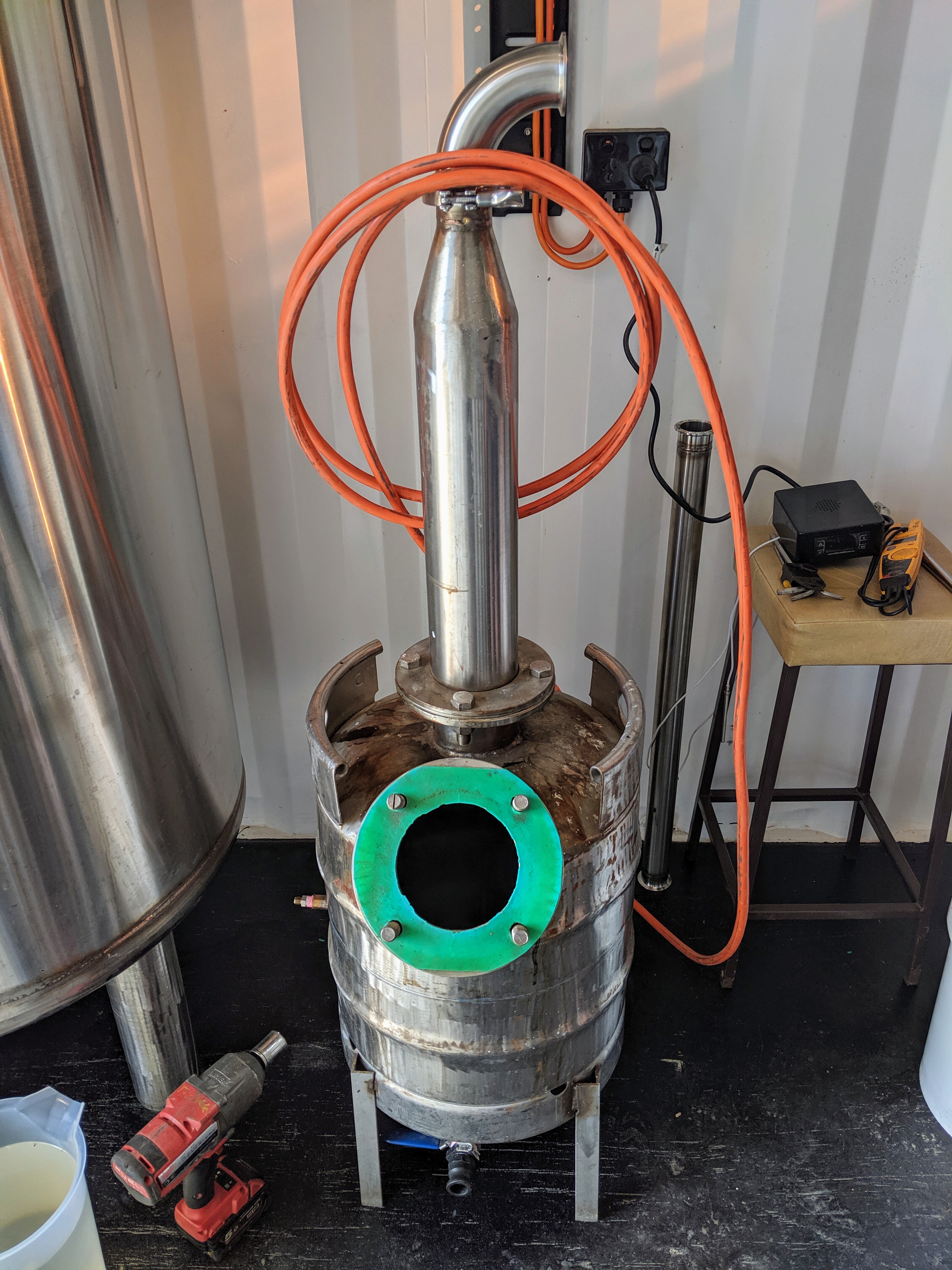 A small stainless steel still built out of a beer keg